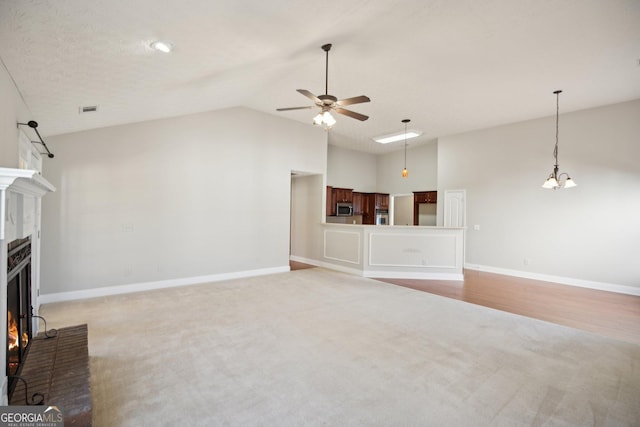 unfurnished living room with baseboards, visible vents, a ceiling fan, light colored carpet, and a brick fireplace