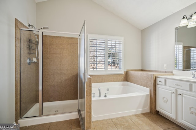 full bath featuring lofted ceiling, a shower stall, vanity, tile patterned flooring, and a bath