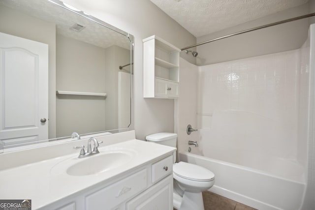 bathroom with bathing tub / shower combination, toilet, tile patterned flooring, a textured ceiling, and vanity