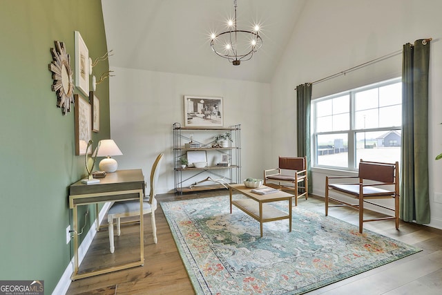 living area with light wood finished floors, baseboards, a chandelier, and high vaulted ceiling