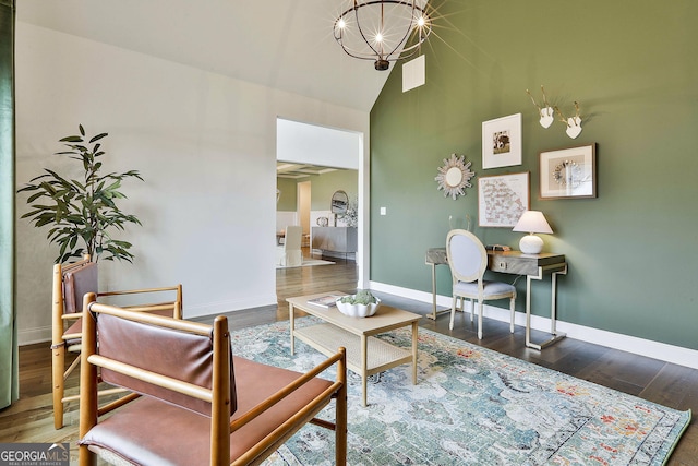 living area featuring baseboards, high vaulted ceiling, dark wood-type flooring, and a notable chandelier