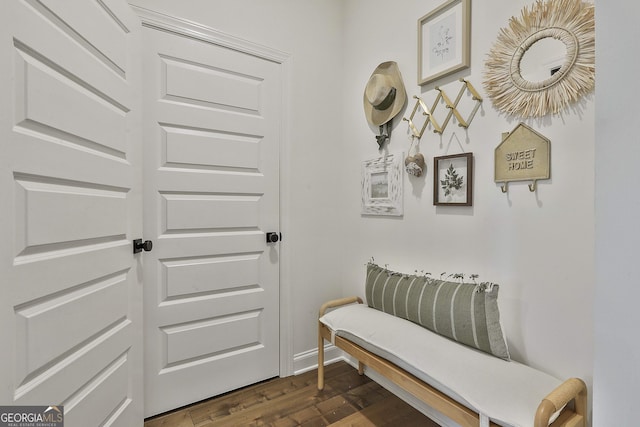 doorway to outside featuring dark wood finished floors and baseboards