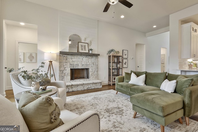 living area featuring recessed lighting, a fireplace, ceiling fan, and wood finished floors