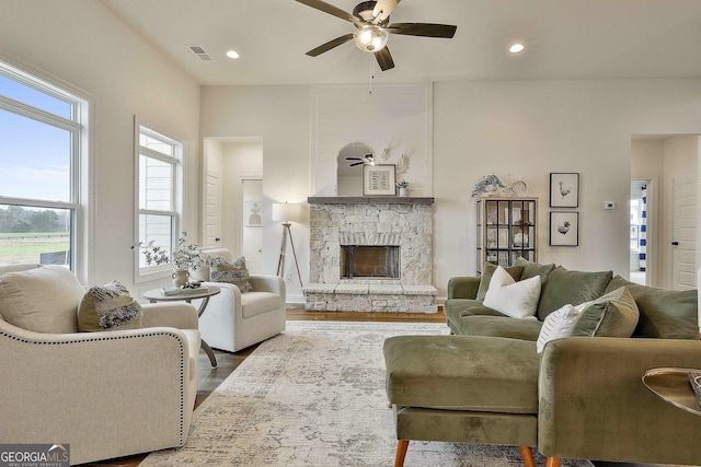 living room featuring visible vents, a ceiling fan, wood finished floors, a fireplace, and recessed lighting