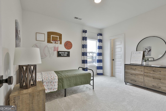 bedroom featuring light colored carpet and visible vents