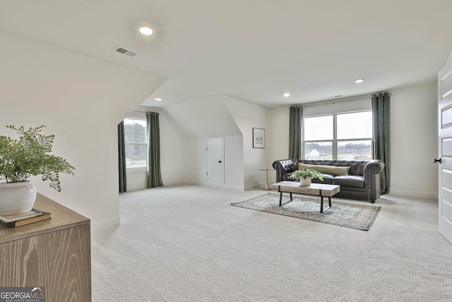 living room featuring light carpet, visible vents, vaulted ceiling, and recessed lighting