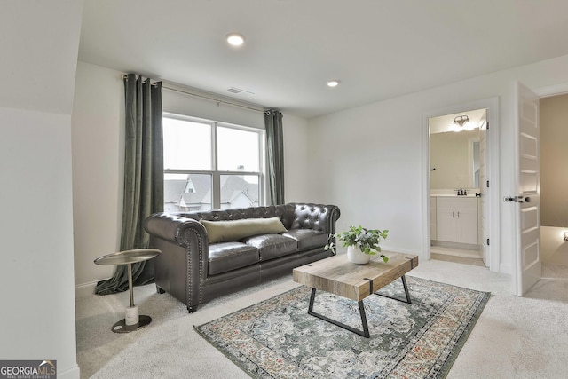 living area with recessed lighting, light colored carpet, and baseboards