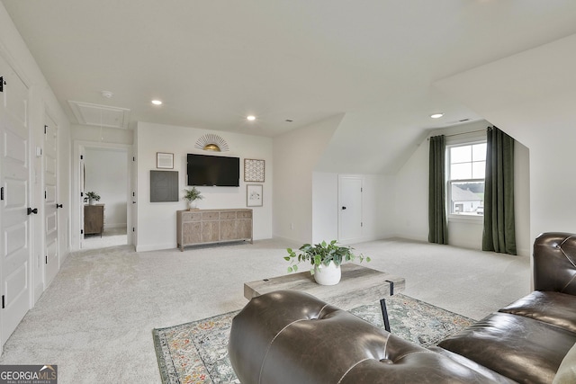 living area with lofted ceiling, recessed lighting, attic access, and light colored carpet