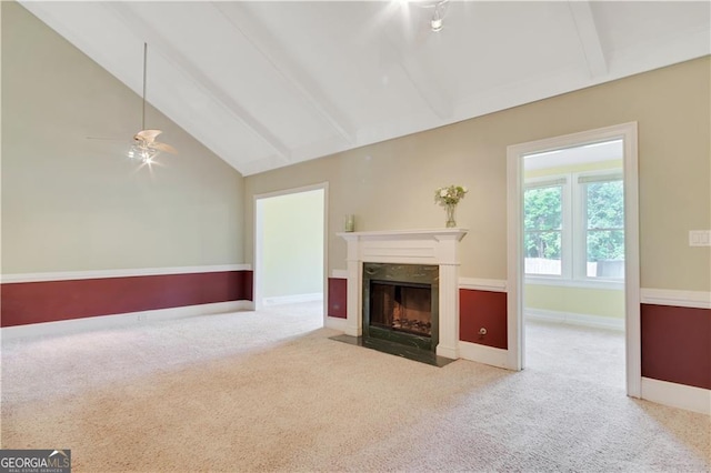 unfurnished living room with baseboards, light colored carpet, beamed ceiling, a fireplace, and high vaulted ceiling