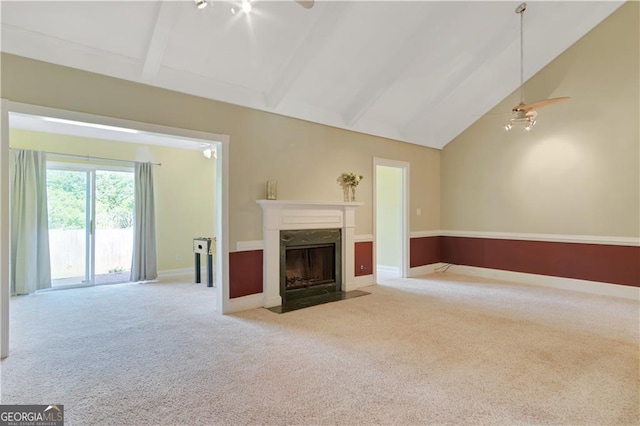 unfurnished living room featuring light carpet, baseboards, a premium fireplace, high vaulted ceiling, and beam ceiling