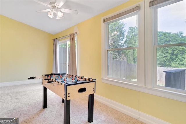 game room with carpet floors, ceiling fan, and baseboards