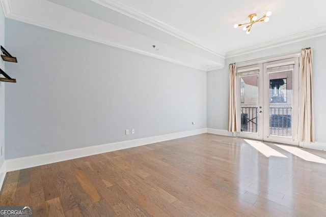 unfurnished room with light wood-style flooring, ornamental molding, baseboards, and french doors