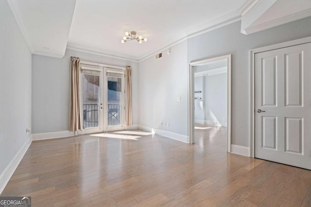 spare room with french doors, crown molding, visible vents, light wood-style floors, and baseboards