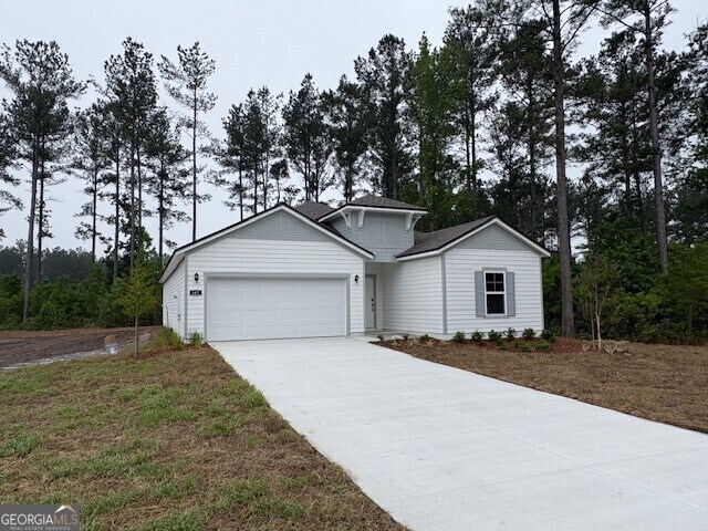 single story home featuring an attached garage and driveway