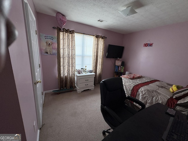 bedroom with visible vents, light carpet, and a textured ceiling