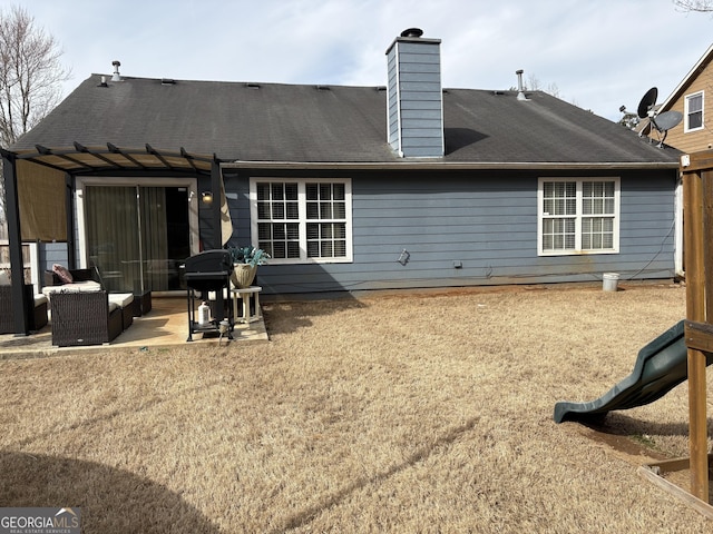 rear view of house featuring a patio, a chimney, and an outdoor hangout area