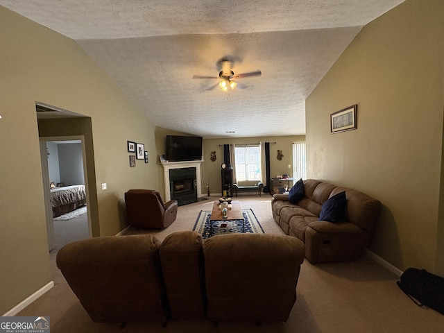 carpeted living area featuring lofted ceiling, a fireplace with flush hearth, baseboards, and a textured ceiling