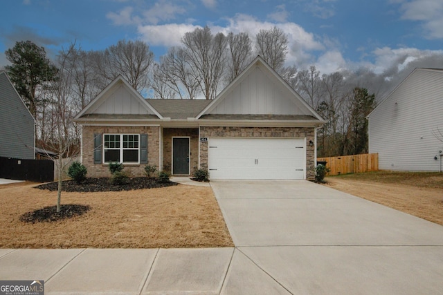 view of front facade with driveway, an attached garage, fence, board and batten siding, and brick siding