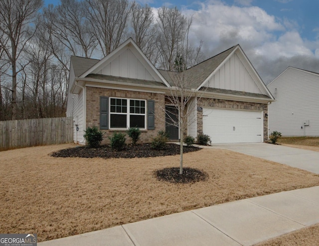 view of front of property featuring brick siding, concrete driveway, an attached garage, board and batten siding, and fence