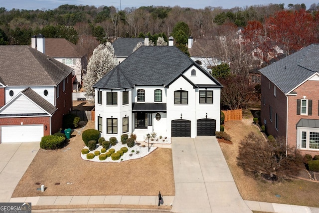 view of front facade with stucco siding, a residential view, roof with shingles, concrete driveway, and an attached garage