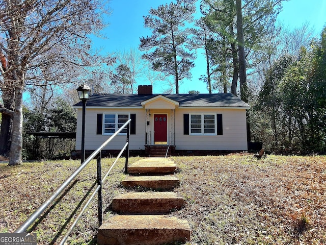 view of front of property with entry steps and a chimney