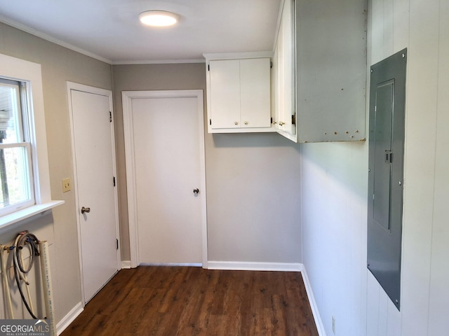 corridor featuring ornamental molding, electric panel, dark wood finished floors, and baseboards