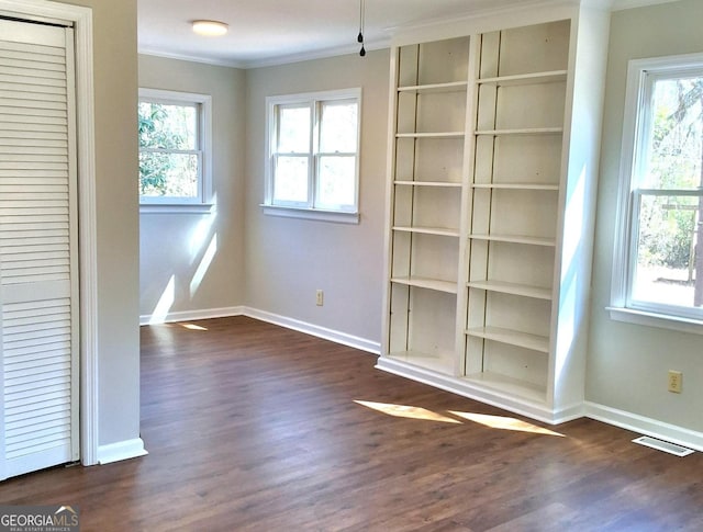 interior space featuring baseboards, visible vents, dark wood-style flooring, and ornamental molding