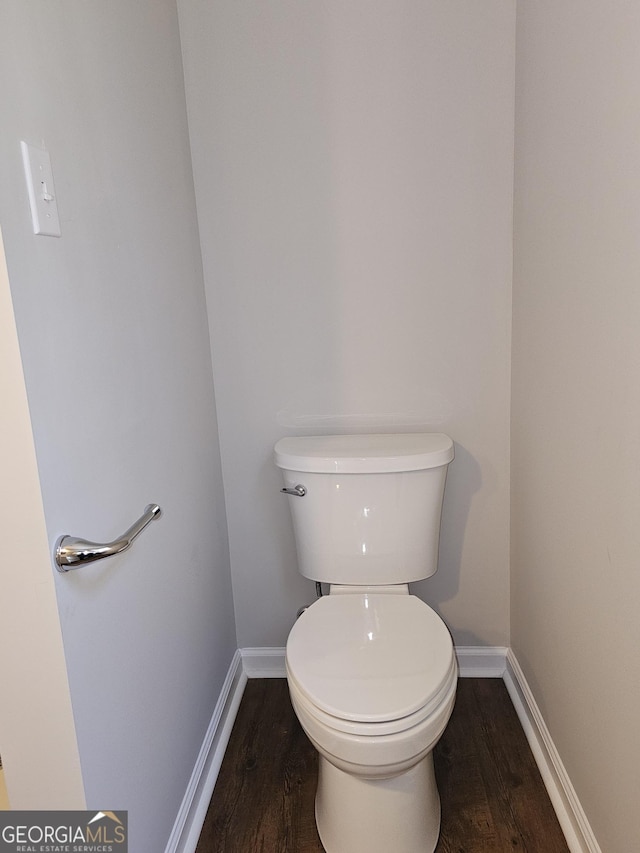 bathroom featuring wood finished floors, toilet, and baseboards