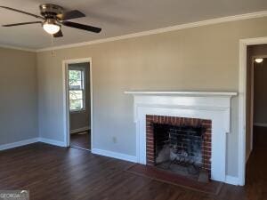 unfurnished living room featuring baseboards, ceiling fan, ornamental molding, dark wood-style flooring, and a brick fireplace