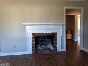 interior details featuring a fireplace, baseboards, and wood finished floors