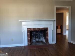 1014 Walnut St, Louisville, GA 30434 - detailed view of wood finished floors and a brick fireplace