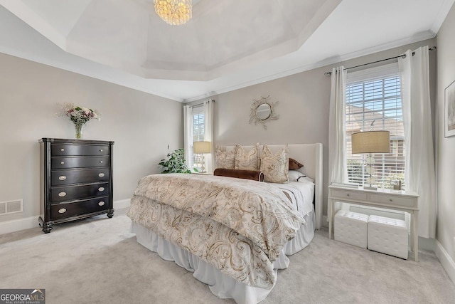 bedroom with carpet flooring, visible vents, baseboards, a raised ceiling, and crown molding