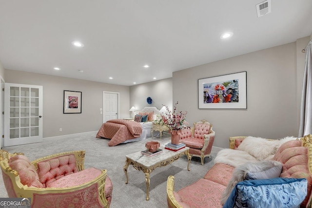 living room with carpet floors, recessed lighting, visible vents, and baseboards