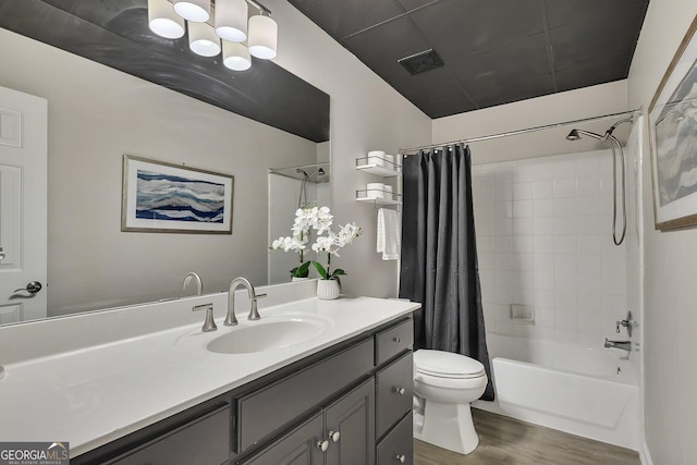 bathroom featuring vanity, shower / tub combo, wood finished floors, and toilet