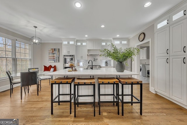 kitchen featuring a spacious island, glass insert cabinets, and white cabinets