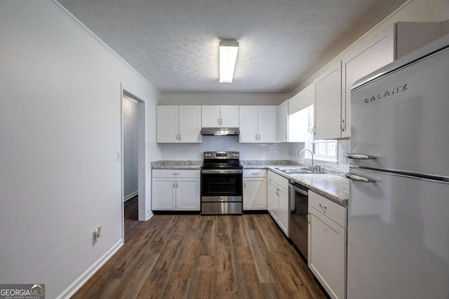 kitchen featuring appliances with stainless steel finishes, white cabinetry, a sink, a textured ceiling, and under cabinet range hood