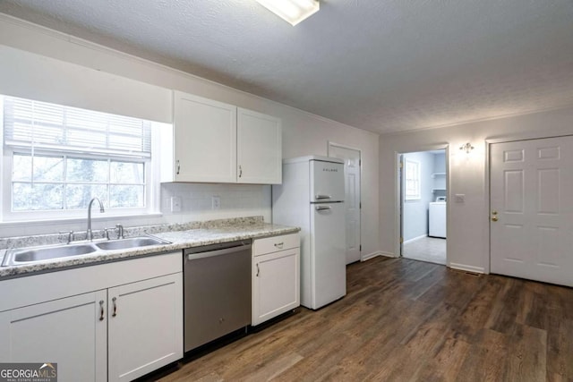 kitchen with freestanding refrigerator, white cabinetry, dishwasher, and a sink