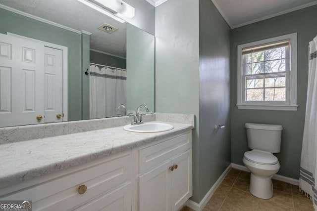 bathroom featuring tile patterned flooring, crown molding, vanity, and toilet