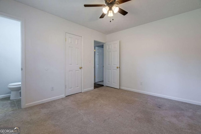 unfurnished bedroom with baseboards, ceiling fan, ensuite bath, and light colored carpet