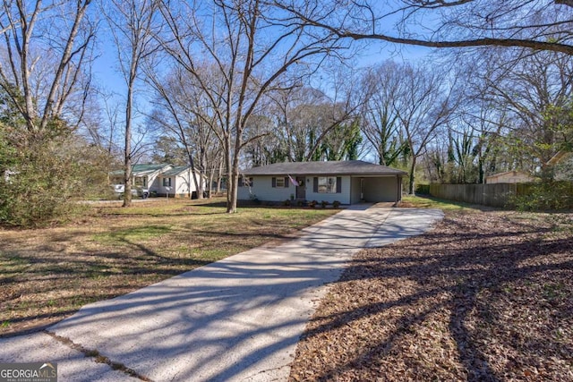 view of front of property with fence and concrete driveway