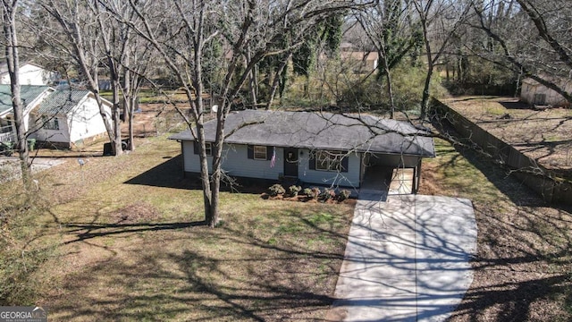 single story home featuring an attached carport, concrete driveway, and a front yard