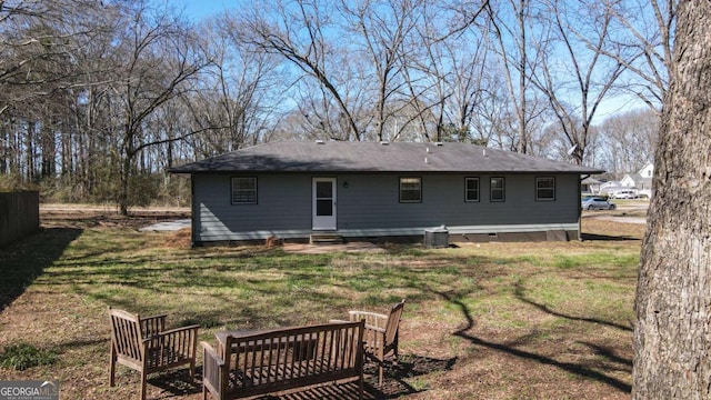 rear view of house featuring crawl space, central air condition unit, a lawn, and entry steps