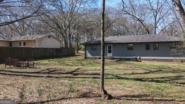 view of yard with entry steps, fence, and central air condition unit