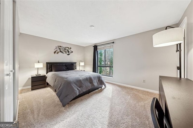 bedroom with carpet floors and baseboards