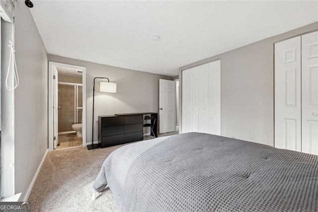 bedroom with multiple closets, light colored carpet, ensuite bath, and baseboards