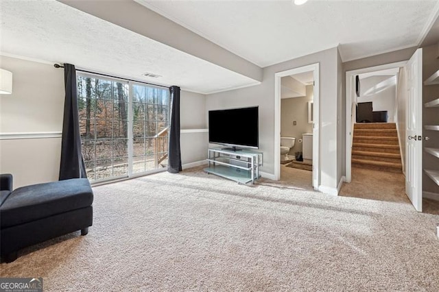 living room with stairs, carpet, and baseboards