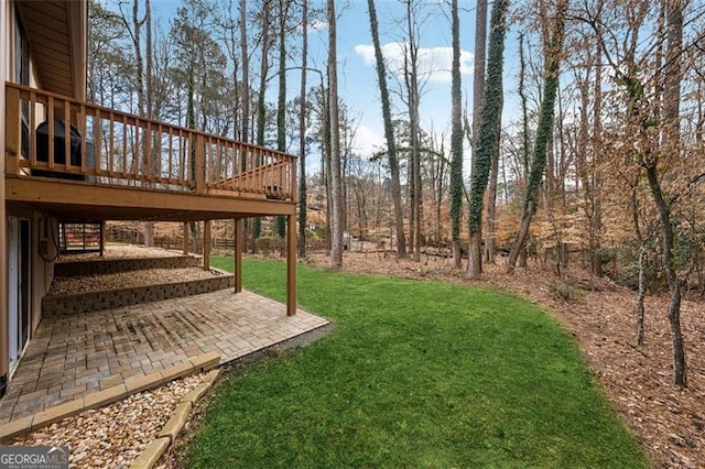 view of yard featuring a patio and a wooden deck