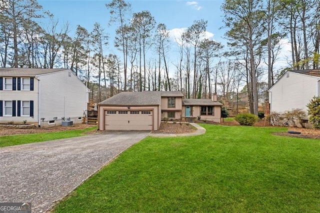 view of front of house with a front yard, driveway, and an attached garage