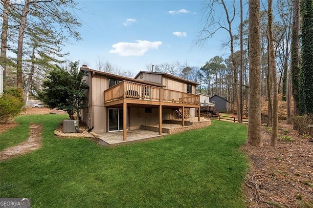 back of house with a deck, a yard, a patio area, and central air condition unit