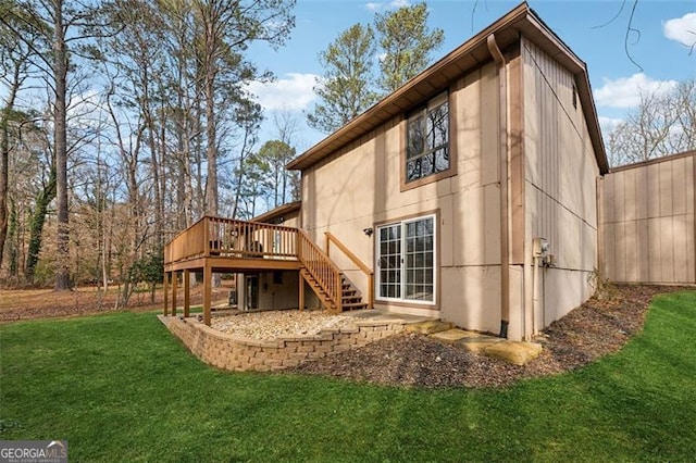 exterior space featuring stairway, a lawn, and a deck